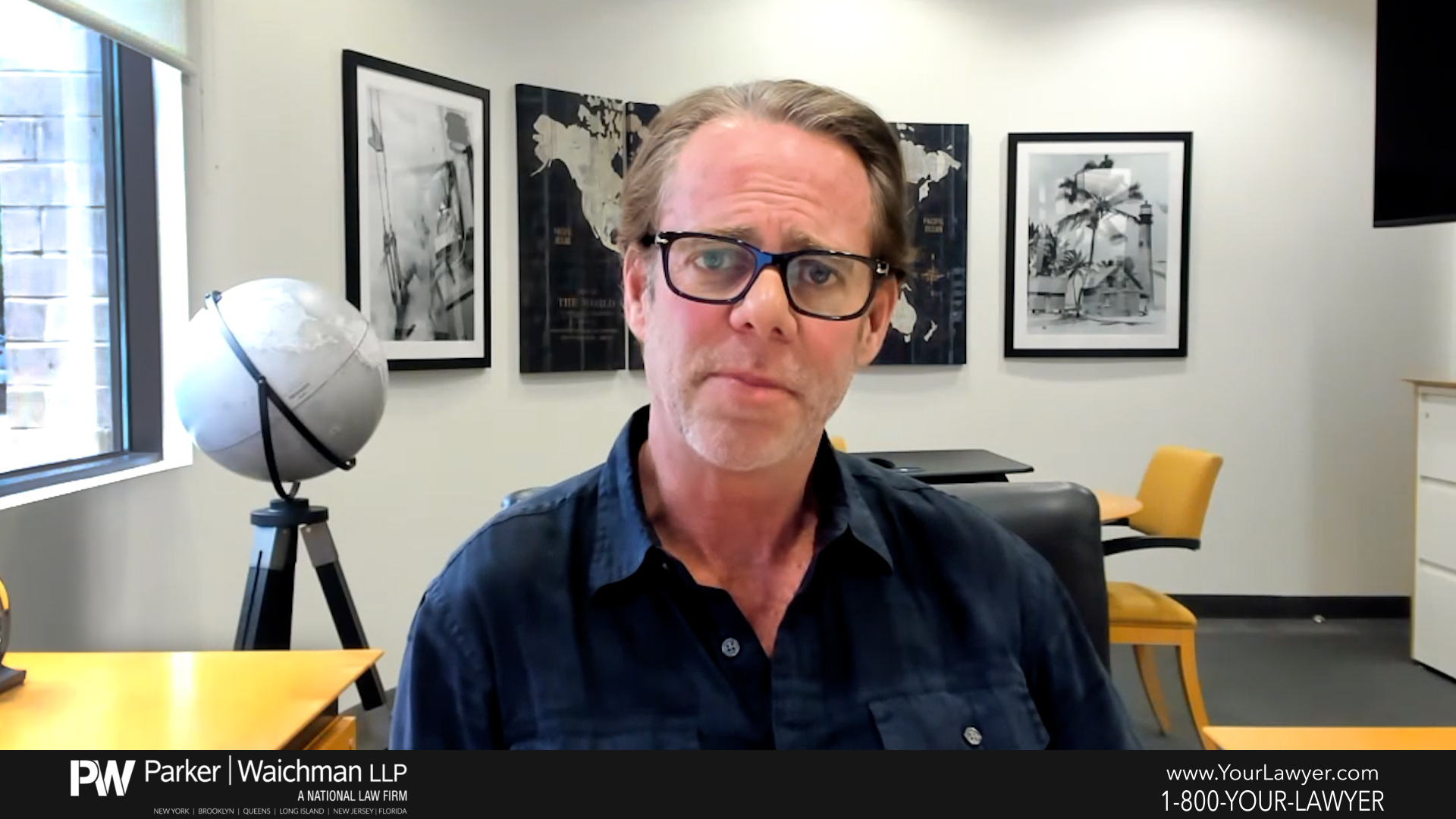 Man with glasses looking at camera, as if in a webinar